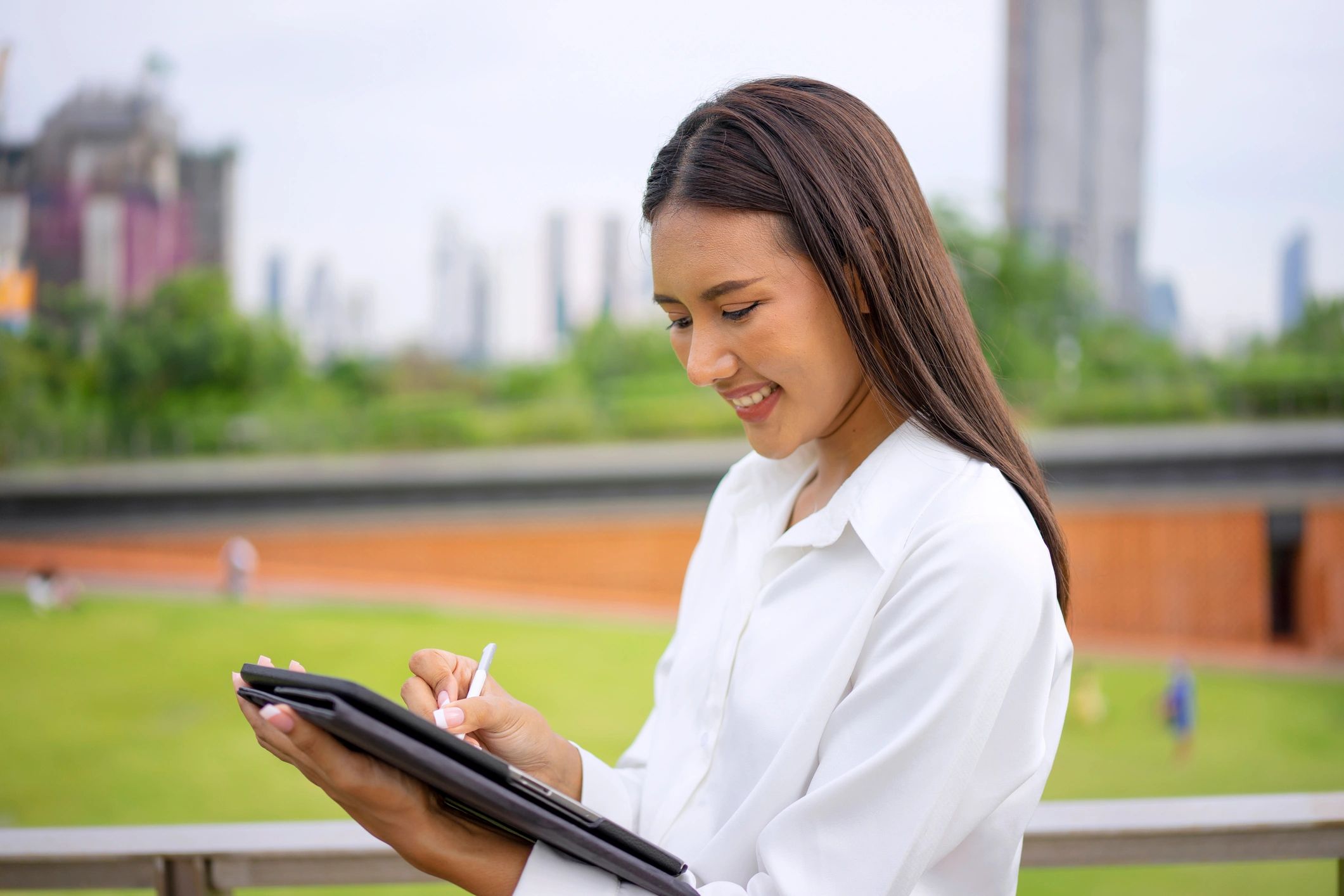 Person using a laptop and phone while studying