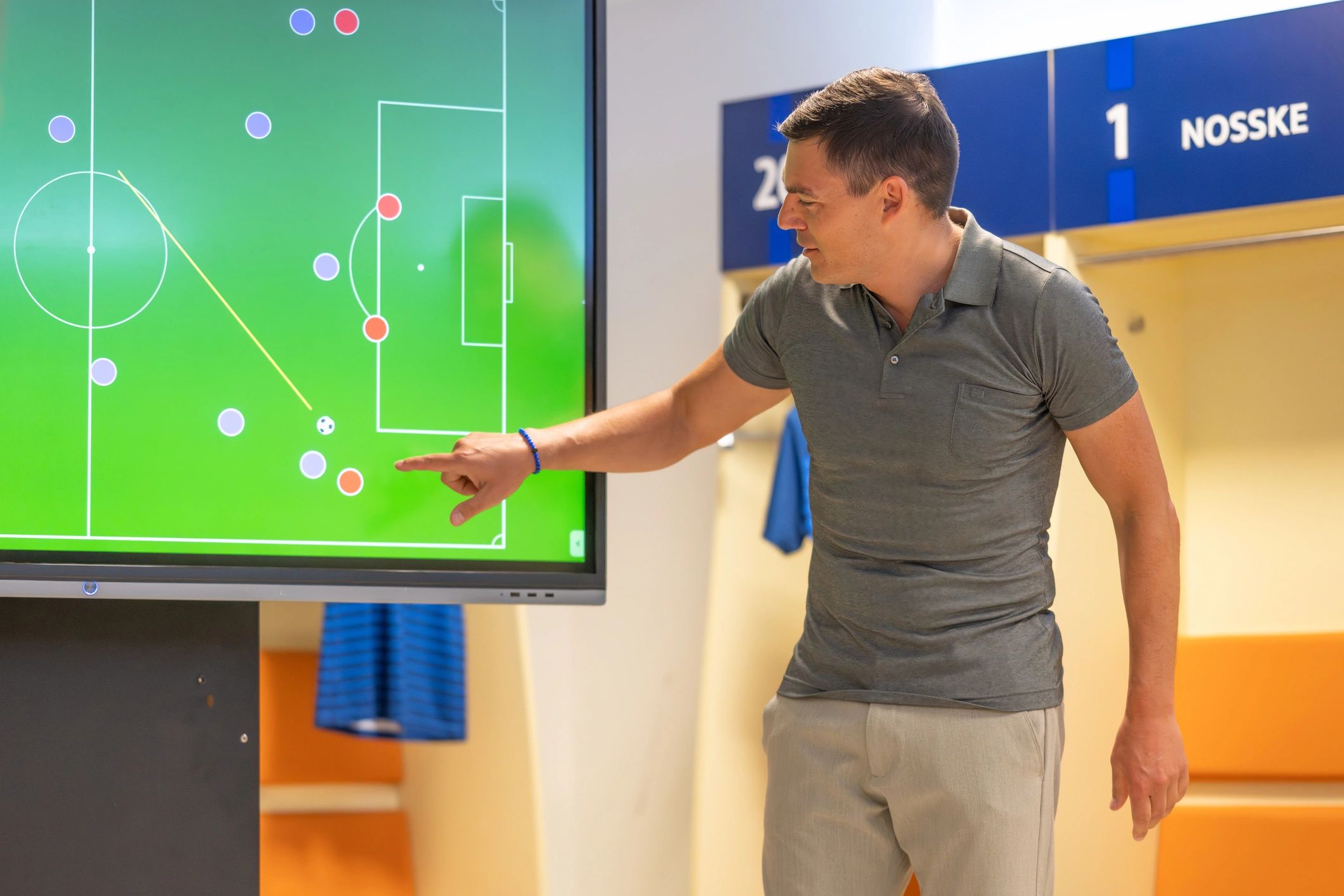 Coach planning tactics on a digital screen